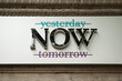 © Theseus - Generic advertisement for the moment of now with crossed out words yesterday and tomorrow on historic facade