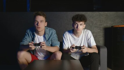 Wall Mural - Two ANGRY guys are sitting on the couch in front of the TV and losing in a game on console