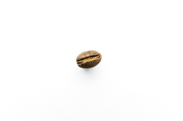 Closeup of a single roasted coffee bean, isolated on a white background