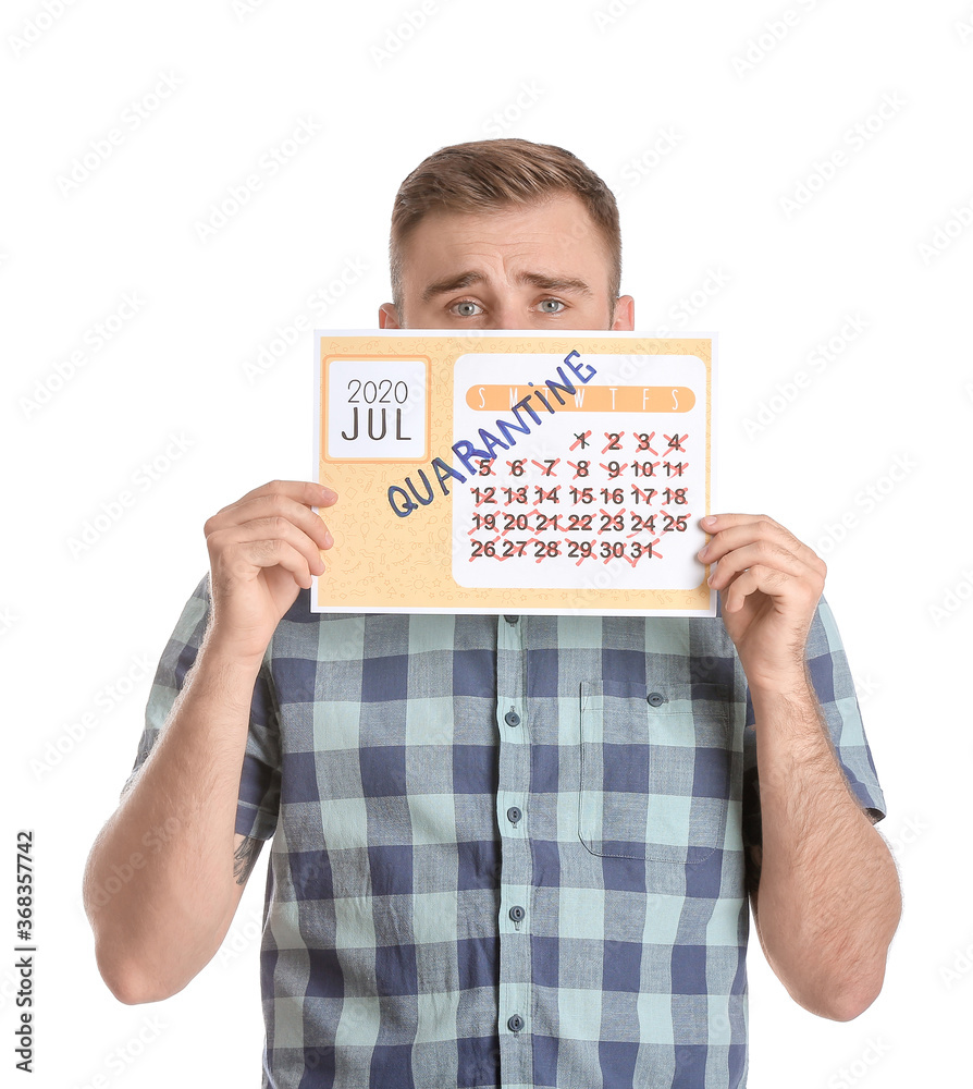 Sad man holding calendar with written word QUARANTINE against white background