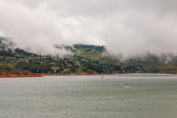 people kitesurfing at lake calima with mist