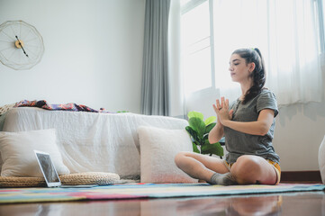 Sport application, Teenage girl practicing yoga and using laptop at home