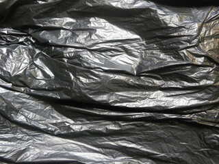 Black color garbage bag textured background