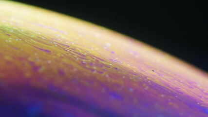 Fluid dynamics and light refraction diffraction in soap bubble surface close up