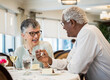 © Erik Isakson - happy senior couple eating meal in restaurant