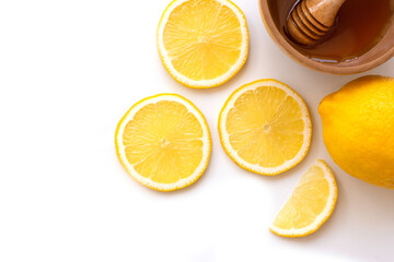 Slice of fresh yellow lemon lime fruit with honey in wooden bowl isolated on white background . Healthcare, beauty and spa concept. Top view. Flat lay.