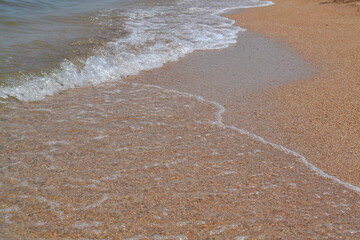 small waves on the black sea beach on a July summer day