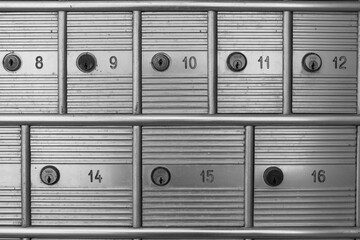 evocative black and white image of old post office mailboxes