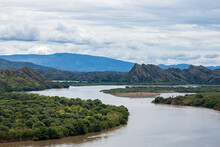 Panorama Photo Of Magdalena River In Colombia. Big Brown River With Mountains At The Background