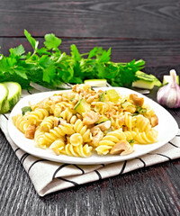 Wall Mural - Fusilli with chicken and zucchini in plate on linen napkin