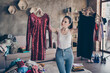 Portrait of her she nice attractive doubtful girl holding in hands hangers two new chic designer couture dress comparing preparing party wear in modern loft industrial interior apartment
