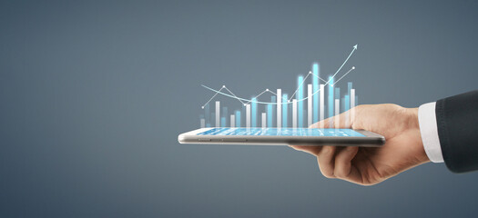 Business plan graph growth increase of chart positive indicators in his business, tablet in hand