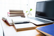 © Lili.Q - Laptop and book study materials on the desk