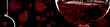 Red wine on black background, abstract splashing. Panoramic banner with copy space
