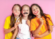© Luiza - Happy Children hold fake mustache and lips on a pink background. Beauty salon.  Hair design salon. Salon photobooth