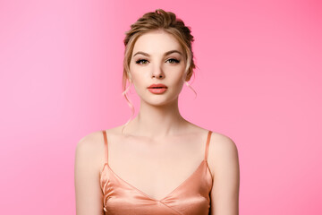 elegant beautiful blonde woman in silk dress isolated on pink