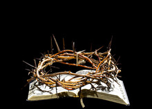 The Crown Of Thorns Lies On The Open Book Of The Bible. Objects On An Isolated Black Background.