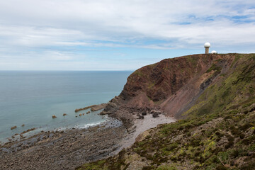 devon coastline near hartland point with radar tower on clifftop