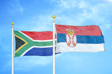 South Africa and Serbia two flags on flagpoles and blue sky