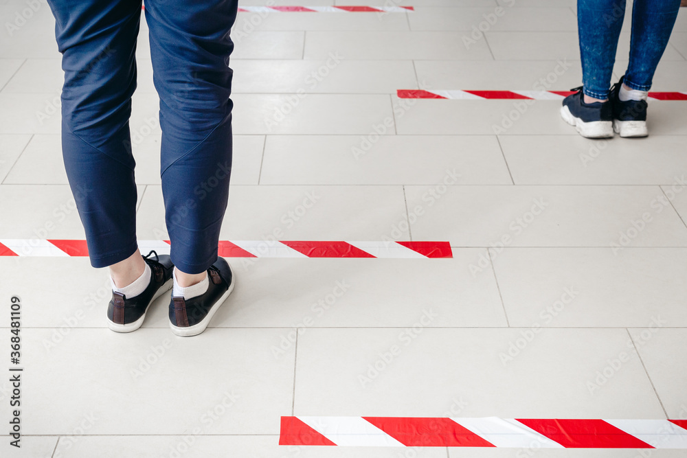 Foto de Stock People stand in line keeping social distance, standing ...