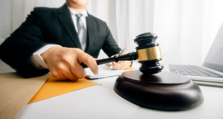 Business and lawyers discussing contract papers with brass scale on desk in office. Law, legal services, advice, justice and law concept picture with film grain effect