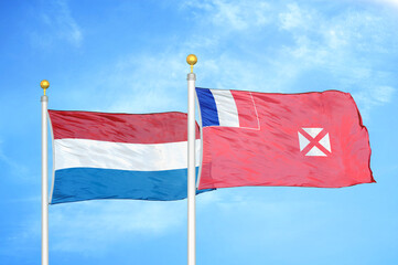 Netherlands and Wallis and Futuna two flags on flagpoles and blue sky