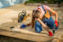 Carpenter Woman Is At Work. Building As A Hobby. Beautiful Woman With Construction Tools