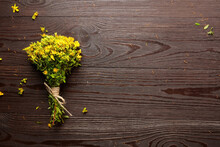 St. John’s Wort (Hypericum Perforatum), Flowering Plant With Yellow Flowers, Healing Herb On Wooden Background