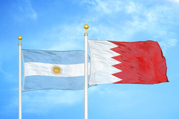 Argentina and Bahrain two flags on flagpoles and blue sky