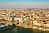 Fototapeta Paryż - Erzsebet Suspension Bridge (Elizabeth) connects the Buda and Pest banks through the Danube. Panormany view of the Buda beach