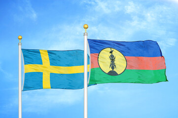 Sweden and New Caledonia two flags on flagpoles and blue sky