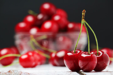 Poster - A small glass bowl with ripe fresh cherry