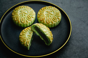 Delicious Chinese traditional pastry green tea crisp. A plate of delicious Chinese dim sum green tea cake. Chinese character translation on dim sum: Tea