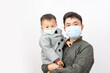 © Mulin - Adults and children wearing masks to protect themselves from disease
