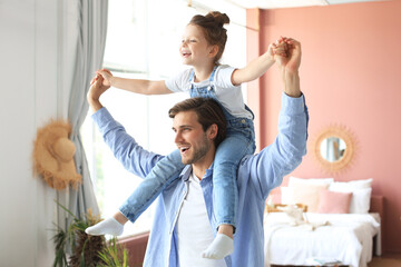 Father and his daughter child girl playing together. Father's day concept.