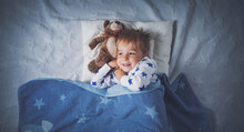 Three Years Old Child Sleeping In Bed