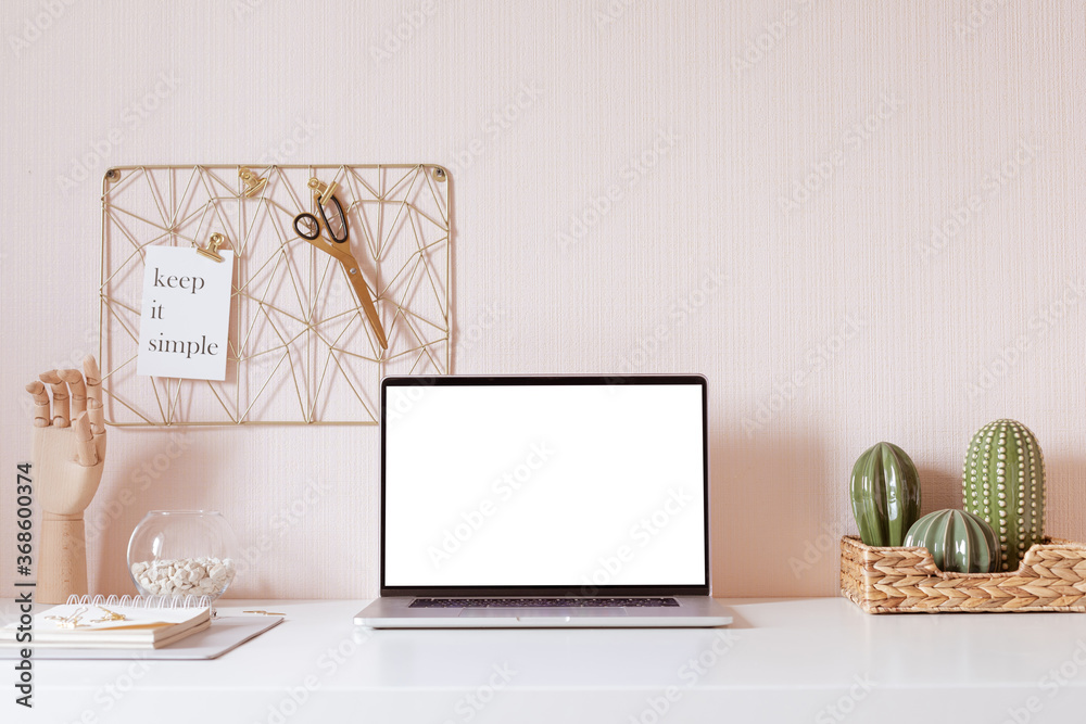 Laptop with blank white screen on office desk interior. Stylish gold workplace mockup table view.  - obrazy, fototapety, plakaty 