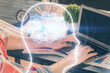 © peshkova - Man with computer background with brain theme hologram. Concept of brainstorm. Double exposure.