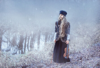 young woman in winter forest. girl in the woods. young woman in a fur coat