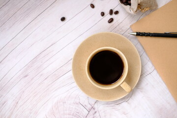 Poster - cup of coffee and coffee beans on table background