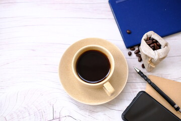 Poster - cup of coffee and coffee beans on table background