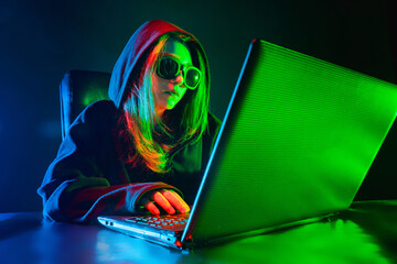 Poster - hacking. hacker near the laptop. girl makes a hacker attack. internet hacking. concept - a member of