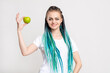 © golubovy - Positive woman with bright blue hair braids holding fresh green apple isolated on white copy space. Healthy nutrition. Detox diet. Organic fruit. Vitamin snack. Antioxidant food. Vegetarian lifestyle.