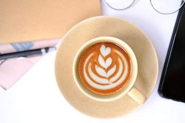 Poster - cup of coffee and coffee latte on table background