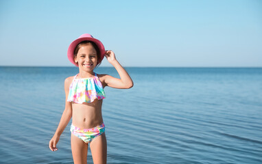 Sticker - Cute little child on sunny day. Beach holiday