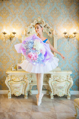 beautiful young woman in ballerina costume with a huge bouquet of blue flowers