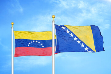 Venezuela and Bosnia and Herzegovina two flags on flagpoles and blue sky