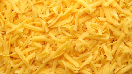 Wall Mural - grated cheddar cheese rotating top view