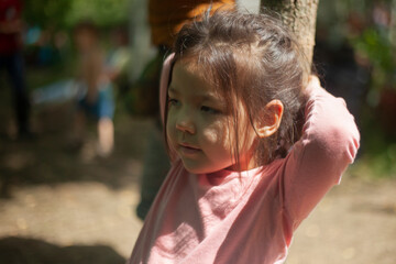 Girl 4 years old in the forest. Little girl of Asian appearance