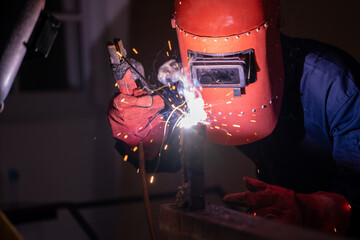 Wall Mural - Metal welding steel works using electric arc welding machine to weld steel at factory. Metalwork manufacturing and construction maintenance service by manual skill labor concept.